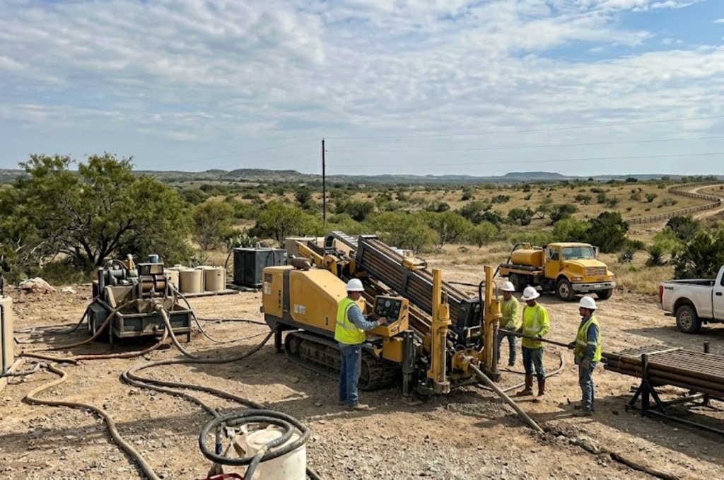 Directional drilling and directional boring in Arizona — Vermeer directional drill with orange and yellow conduit spools on an open Arizona desert bore site